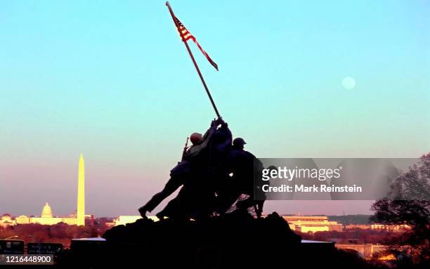 The United States flag flies over the Marine Corps War Memorial at sunset. Arlington Virginia,1990