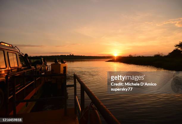 the paraa ferry on the nile river at sunset - murchison falls national park stock pictures, royalty-free photos & images