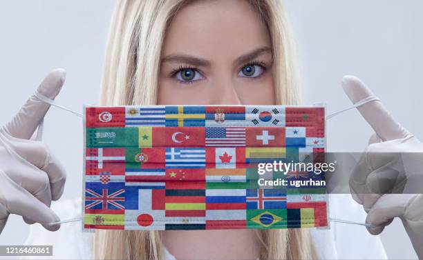 woman wears flags printed mask. - face shield stock pictures, royalty-free photos & images