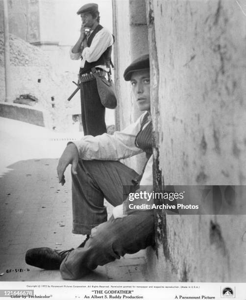 Al Pacino sitting in a doorway in a scene from the film 'The Godfather', 1972.