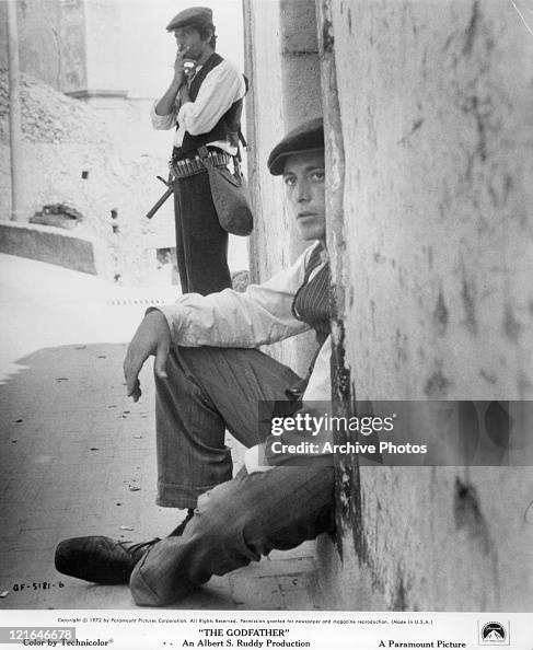Al Pacino sitting in a doorway in a scene from the film 'The... News