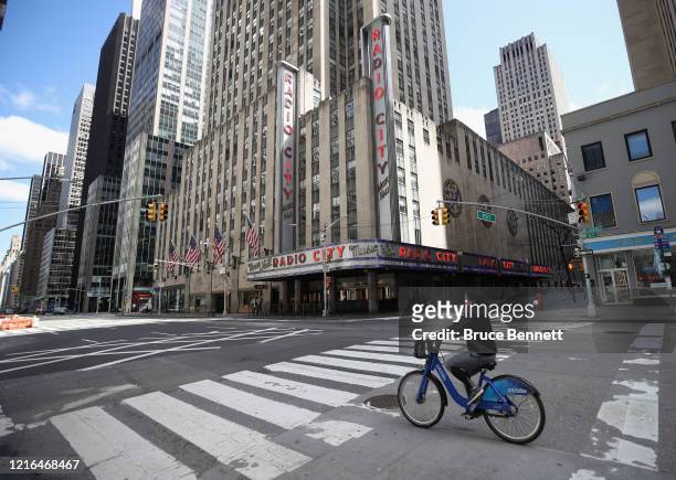 Bicyclist moves past Radio City Music Hall on Sixth Avenue on April 02, 2020 in New York City. Currently, over 92,000 people in New York state have...