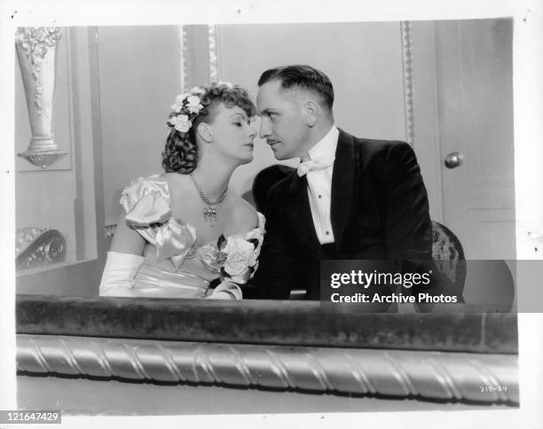 Greta Garbo and Fredric March sitting in formal wear in a scene from the film 'Anna Karenina', 1935.