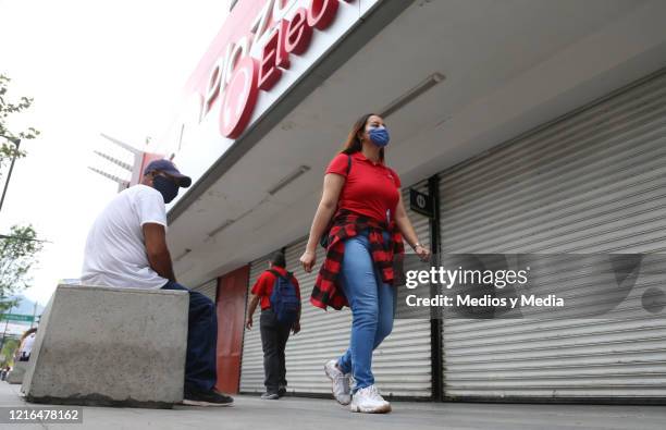 Worker of the Plaza de la Tecnología de Monterrey sitting in front of his premises closed by the police to prevent the spread of the Coronavirus, on...