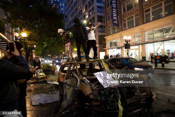 Protesters riot in the streets following a peaceful rally expressing outrage over the death of George Floyd on May 30, 2020 in Seattle, Washington....