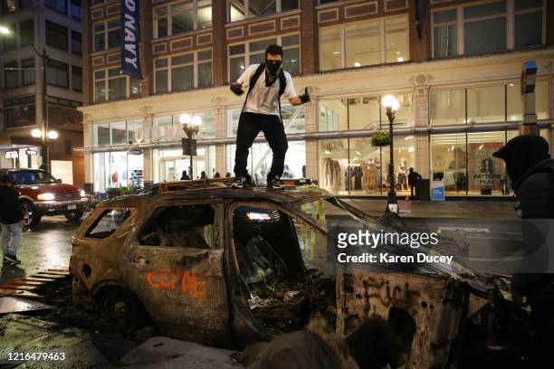 Protesters riot in the streets following a peaceful rally expressing outrage over the death of George Floyd on May 30, 2020 in Seattle, Washington....