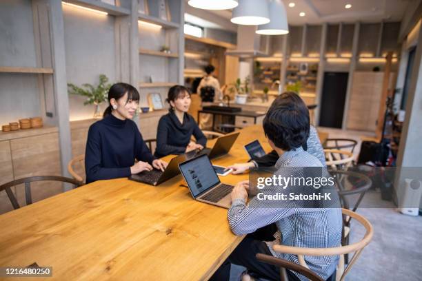 business people having discussion in comfortable meeting space - business meeting cafe stock pictures, royalty-free photos & images