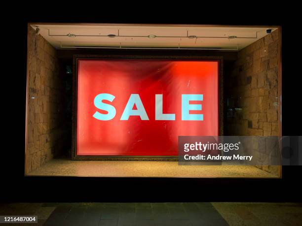 shop window display with large red illuminated sale sign during coronavirus, covid-19 pandemic, australia - montra imagens e fotografias de stock