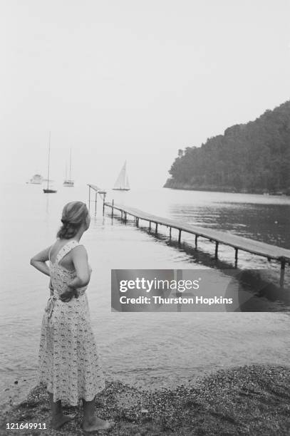 Woman surveys the view from Paraggi Beach, near the tourist resort of Portofino, Italy, August 1952. Original Publication : Picture Post - 6023 -...