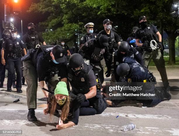 Protesters are held down during a night of clashes between protesters and Detroit Police Officers, violence returned to downtown Detroit as police...