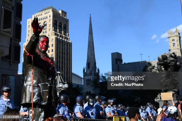 Police officers guard the controversial Frank Rizzo statue as protestors clash with police near City Hall, in Philadelphia, PA on May 30, 2020....
