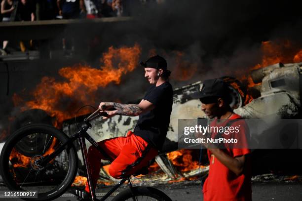 An overturned police cruiser burns as protestors clash with police near City Hall, in Philadelphia, PA on May 30, 2020. Cities around the nation see...