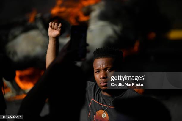 An overturned police cruiser burns as protestors clash with police near City Hall, in Philadelphia, PA on May 30, 2020. Cities around the nation see...
