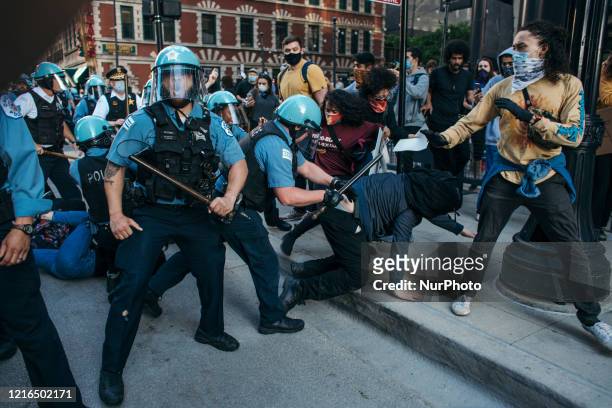 Protesters clash with police in Chicago , on May 30, 2020 during a protest against the death of George Floyd, an unarmed black man who died while...