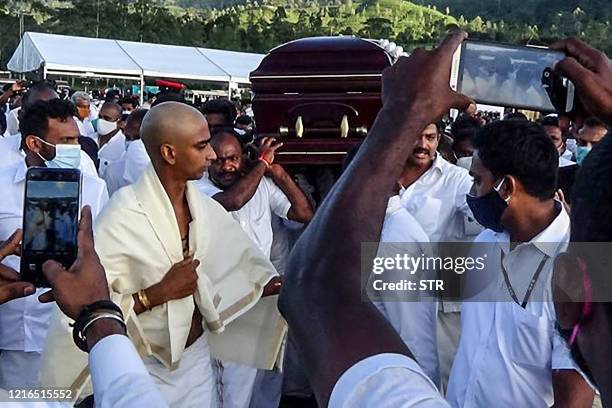 Party supporters carry the coffin of late tea plantation trade union leader and government minister Arumugam Thondaman in the central city of Norwood...