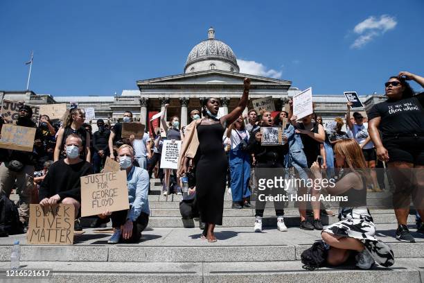 People hold placards as they join a spontaneous Black Lives Matter march at Trafalgar Square to protest the death of George Floyd in Minneapolis and...