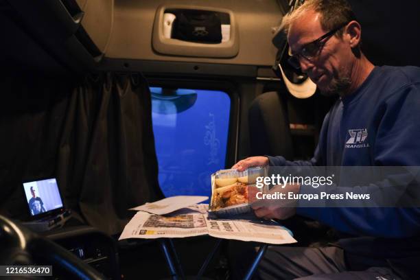 The photographer, Fabian A. Pons, take a picture to the trucker named Ramón prepares to eat dinner in his truck while watching an episode of Fast and...