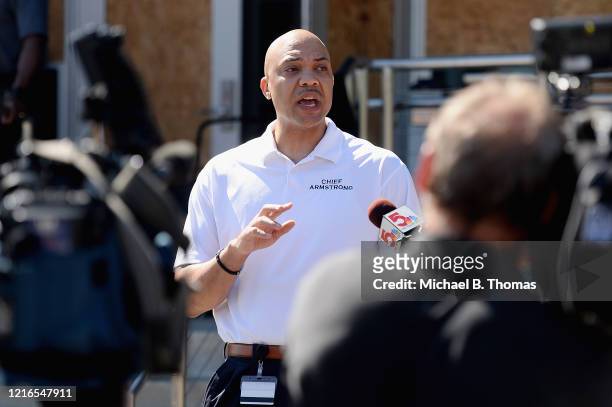 Ferguson Police Chief, Jason Armstrong speaks to media as volunteers help cleanup from an overnight clash between protesters and law enforcement at...