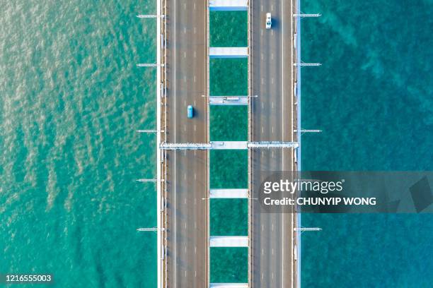 semi-truck crossing oresund bridge - symmetry stock pictures, royalty-free photos & images