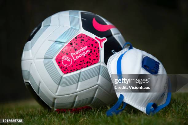 The official Nike Premier League match ball with a protective mask. The Coronavirus pandemic has spread to many countries across the world, claiming...