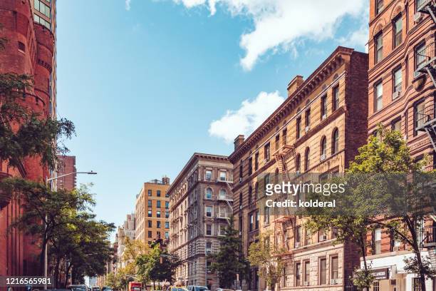 street in midtown upper manhattan during sunny summer day - central park view stock pictures, royalty-free photos & images