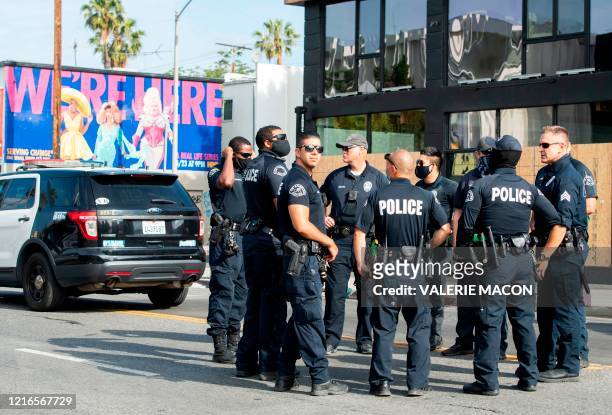 Police gather on Melrose Avenue on May 31, 2020 in Los Angeles, California. - Clashes broke out and major cities imposed curfews as America began...