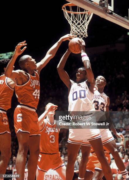 Univesity of Connecticut center Cliff Robinson, , rebounds the ball against Syracuse University forward Derrick Coleman, , during a Big East game in...