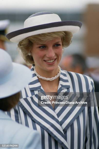 British royal Diana, Princess of Wales , wearing a blue-and-white striped jacket, a dark blue skirt with a white hat with blue trim, during a visit...