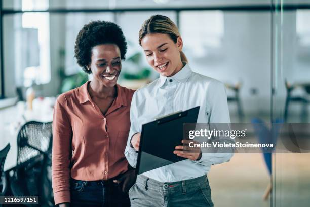 confident female business team. - reading contract stock pictures, royalty-free photos & images