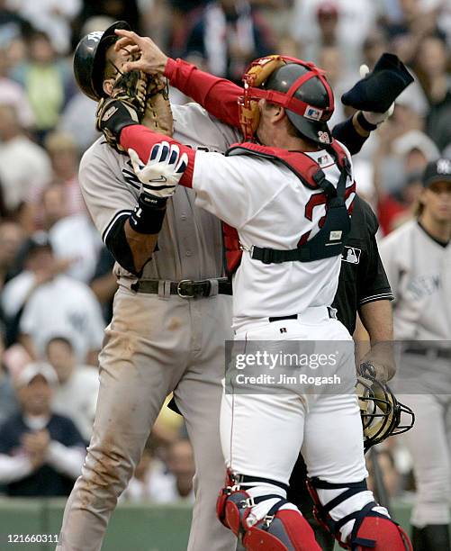 Boston Red Sox catcher Jason Varitek, right, strikes New York Yankees batter Alex Rodriguez at Fenway Park in Boston. The two fought after Rodriguez...