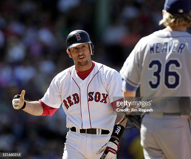 Boston Red Sox batter Nomar Garciaparra, after colliding with Los Angeles Dodgers pitcher Jeff Weaver on the base path, has words with Weaver at...