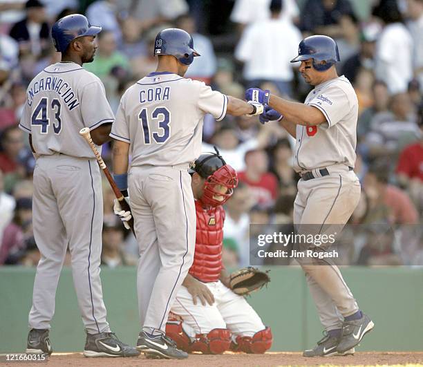 Boston Red Sox catcher Doug Mirabelli, center, looks as Los Angeles Dodgers' Olmedo Saenz, right, is being congratulated by his teammates after Saenz...