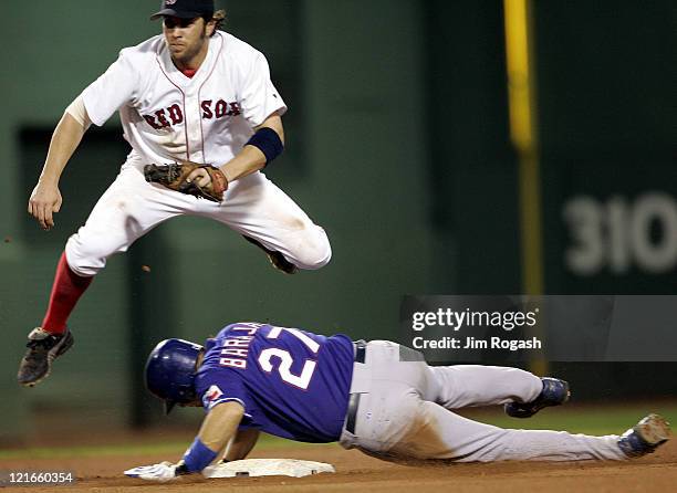 Boston Red Sox second baseman Mark Bellhorn leaps over Texas Rangers base runner Rod Barajas in an effort to turn the double play, Saturday, July 10,...