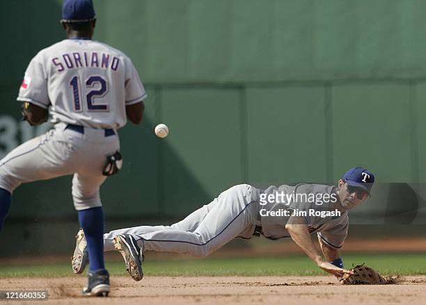 Against the Boston Red Sox, Texas Rangers shortstop Michael Young, right, flips the ball to second baseman Alfonso Soriano for the out. The Rangers...