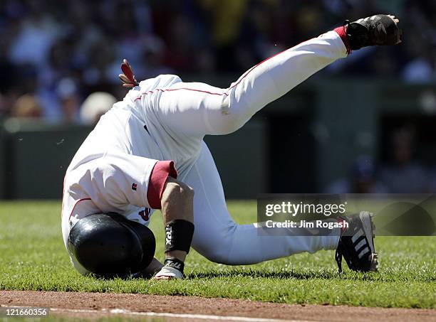 Boston Red Sox batter Nomar Garciaparra tumbles after colliding with Los Angeles Dodgers pitcher Jeff Weaver on the base path at Fenway Park in...