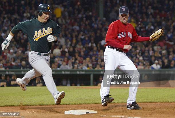 Boston Red Sox pitcher Derek Lowe is late getting to the base, allowing Oakland Athletics base runner Erubiel Durazo to reach first base safely. The...