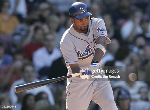 Against the Boston Red Sox, Los Angeles Dodgers' Juan Encarnacion keeps his eye on the ball during an at-bat at Fenway Park in Boston, Massachusetts...