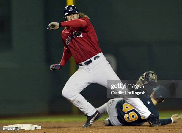 Boston Red Sox base runner Johnny Damon, front, collides with Oakland Athletics second baseman Marco Scutaro. The Red Sox beat the A's 9-6 at Fenway...