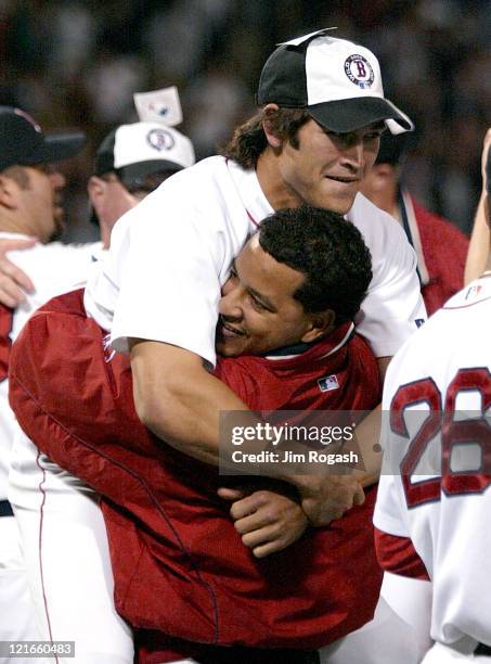 Boston Red Sox's Nomar Garciaparra Manny Ramirez lifts teammate Johnny Damon in the air in celebration after the Red Sox clinched a playoff spot in...