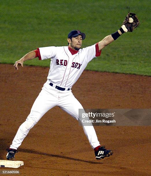 Boston Red Sox's Nomar Garciaparra reaches to catch a throw to acquire an out against the Baltimore Orioles but is unable to turn the double play,...
