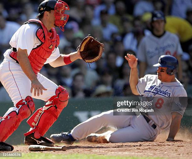 Boston Red Sox catcher Doug Mirabelli, left, waits for the throw as Los Angeles Dodgers base runner Olmedo Saenz scores a run at Fenway Park in...