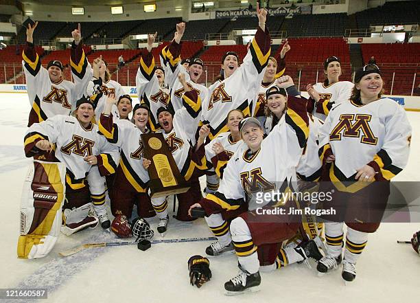 Minnesota poses for a team photo with the NCAA trophy after beating Harvard 6-2 at the final round of the NCAA 2004 Women's Frozen Four at the...