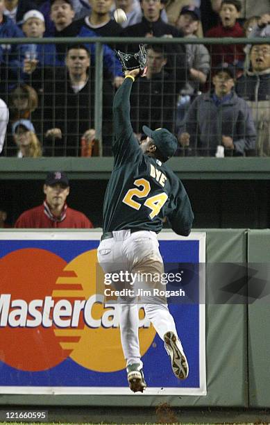 Oakland Athletics right fielder Jermaine Dye makes a leaping catch against the Boston Red Sox. The Red Sox beat the A's 9-6 at Fenway Park in Boston...