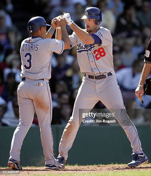Against the Boston Red Sox, Los Angeles Dodgers' Cesar Izturis, left, congratulates Jason Werth after Werth hit a home run at Fenway Park in Boston,...