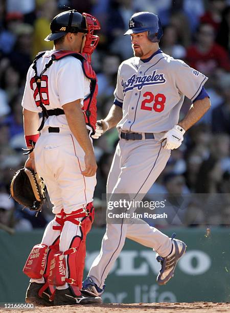 Boston Red Sox catcher Doug Mirabelli,watches as Los Angeles Dodgers' Jayson Werth scores at Fenway Park in Boston, Massachusetts on June 12, 2004.
