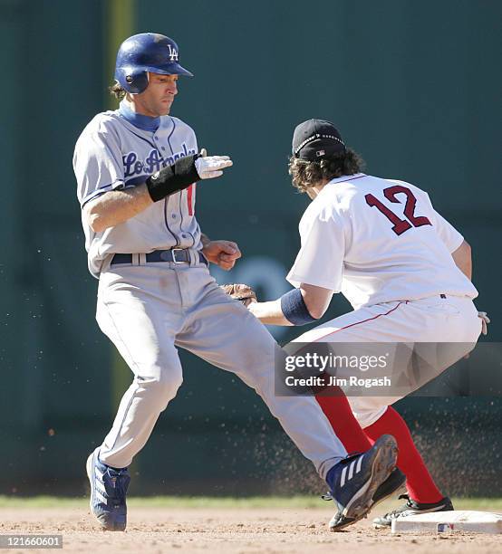 Los Angeles Dodgers' Shawn Green runs back to second as Boston Red Sox Mark Bellhorn awaits a throw from the outfield at Fenway Park in Boston,...
