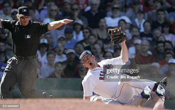 Boston Red Sox third baseman Kevin Youkilis reacts to q call by third base umpire Brian Runge in favor of Los Angeles Dodgers' Shawn Green at Fenway...