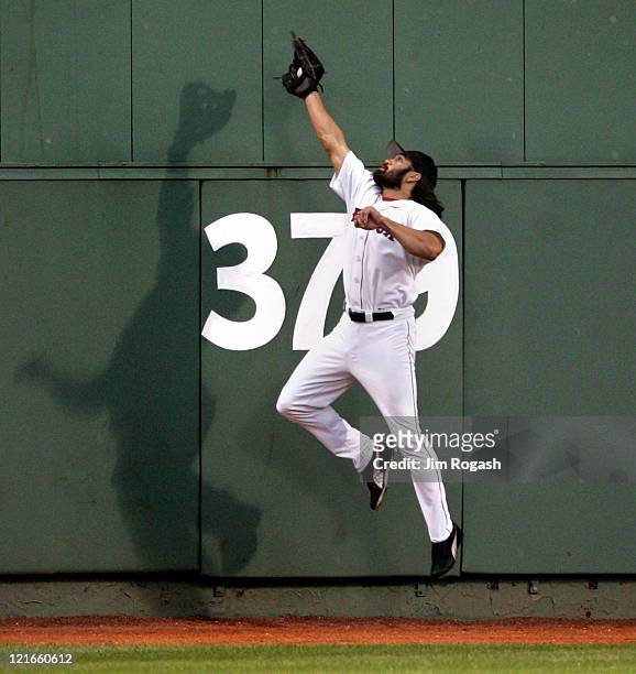 Boston Red Sox outfielder Johnny Damon makes a leaping catch against the Texas Rangers Saturday, July 10, 2004. The Red Sox won 14-6 at Fenway Park...