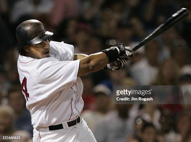 Boston Red Sox batter Manny Ramirez makes contact against the Texas Rangers, Saturday, July 10, 2004. Ramirez hit two home runs in the game. The Red...
