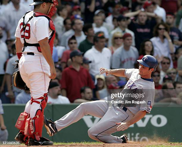 Against the Boston Red Sox, Texas Rangers base runner Jason Conti scores the winning run. The Rangers beat the Red Sox 6-5 at Fenway Park in Boston...